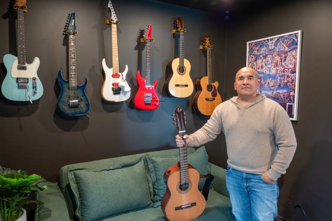 Joshua Rogers, 50, with his guitar collection in his exclusive private studio. Photo / David Hall